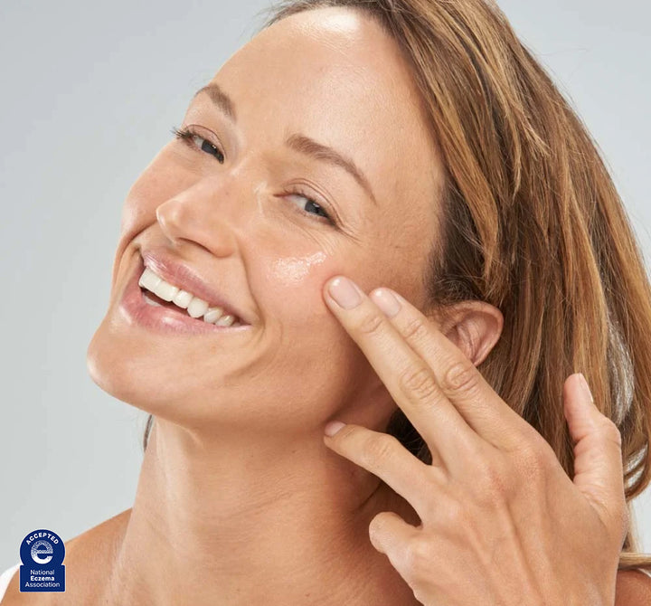 A woman is applying FarmHouse Fresh Flat Out Firm Hyaluronic Acid Peptide Firming Serum onto her faced to instantly firm and renew her complexion.
