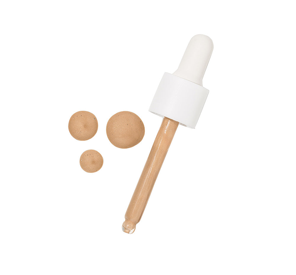Tint-sational Serum dropper with light to medium serum drops on white background.