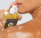 A woman is applying FarmHouse Fresh Agave Nectar Ageless Body Oil to deeply hydrate her skin.