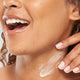 A woman is applying FarmHouse Fresh Stunning Returns Ultra-Rich Bakuchiol Butter on her neck to plump and nourish skin.