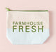 A canvas cosmetic bag with FarmHouse Fresh printed on it that houses all the bodycare products that come in Velvet Slippers Limited Edition Gift set.