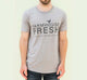 A man wearing a grey FarmHouse Fresh Donation T-Shirt supporting farm animals at the FHF Sanctuary with every purchase.