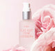 A bottle of FarmHouse Fresh Flat Out Firm Hyaluronic Acid Peptide Firming Serum next to rose flowers that represent the organic rose hydrosol and other natural ingredients of this face serum.