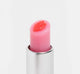 The top of an open tube of FarmHouse Fresh Strawberry Mood Fruit tinted lip balm that nourishes and soothes dry lips.