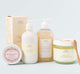 A set of Rainbow Bubbletini body care products by Farmhouse Fresh, including body polish, body wash, shea butter body lotion and a body balm.