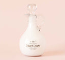 FarmHouse Fresh Sweet Cream Body Milk Lotion in a ready-to-gift Decorative Cruet on a pink background.