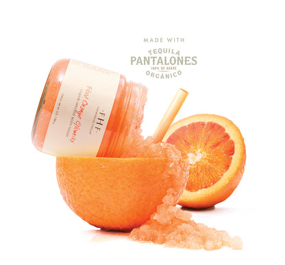 Blood Orange Glowrita body polish with Pantalones Blanco tequila bottle and fresh orange halves