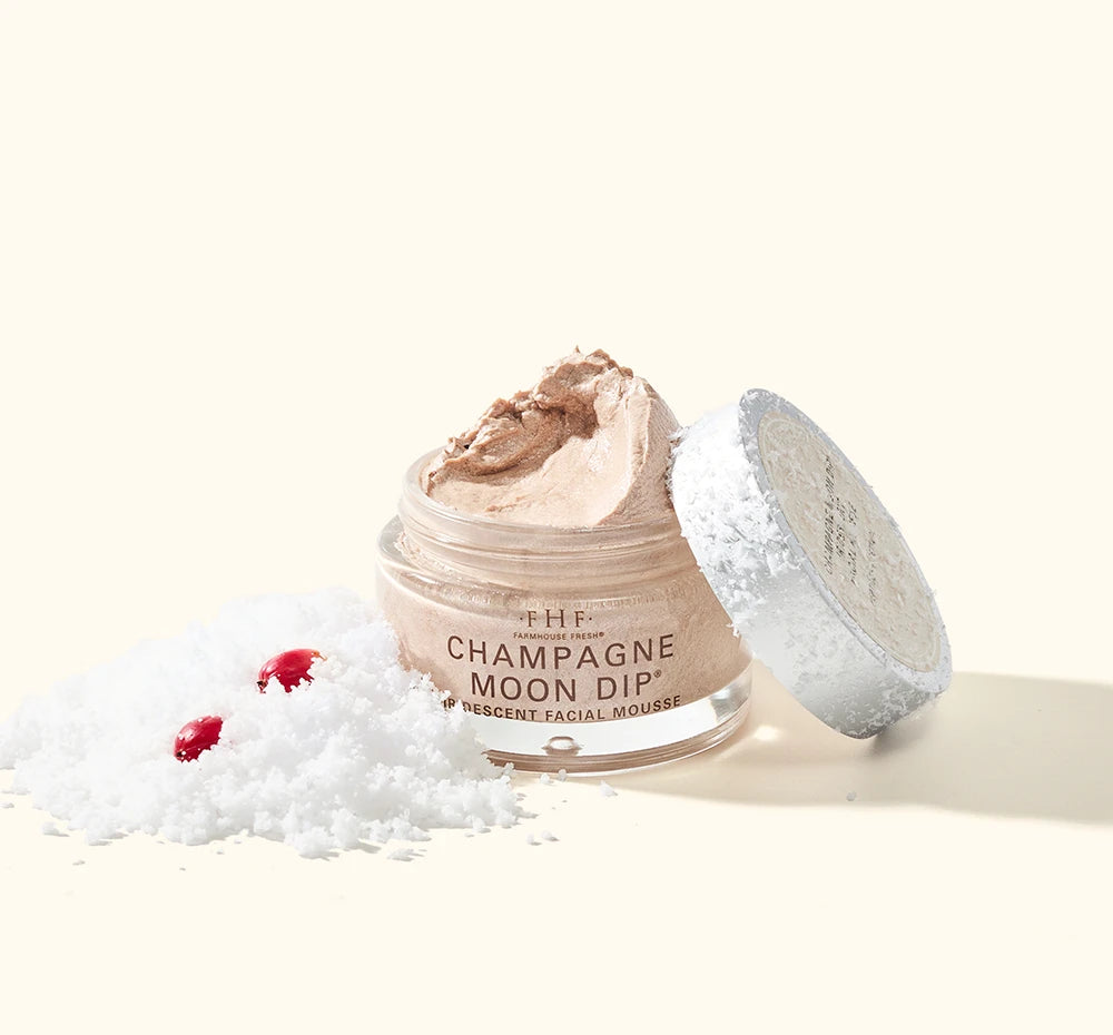 FarmHouse Fresh Champagne Moon Dip Ageless Facial Sleep Mousse in snow with festive red berries for the holidays.