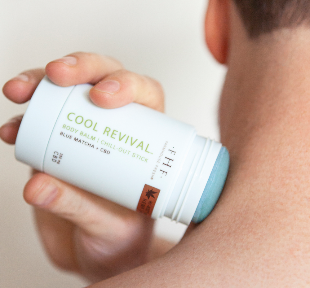 A man applying on his neck FarmHouse Fresh Cool Revival body balm with CBD that provides relief to tired muscles and dry, chapped skin.