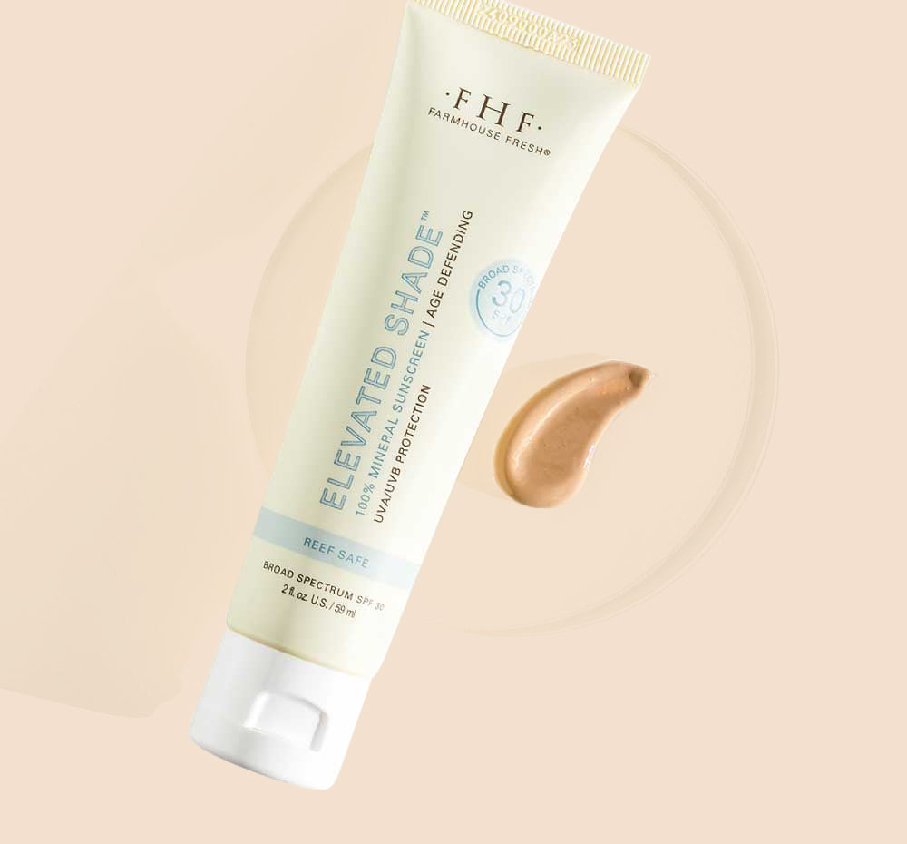 A tube and a swatch of Farmhouse Fresh's Elevated Shade® tinted sunscreen showing its lightweight texture.