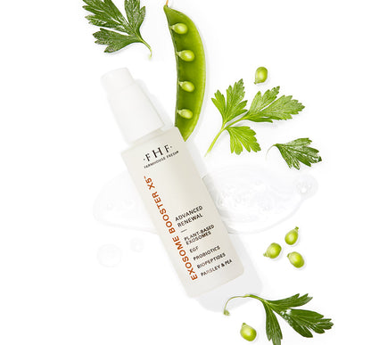 FHF Exosome Booster X5 skincare product surrounded by green parsley leaves and pea pods on a white background