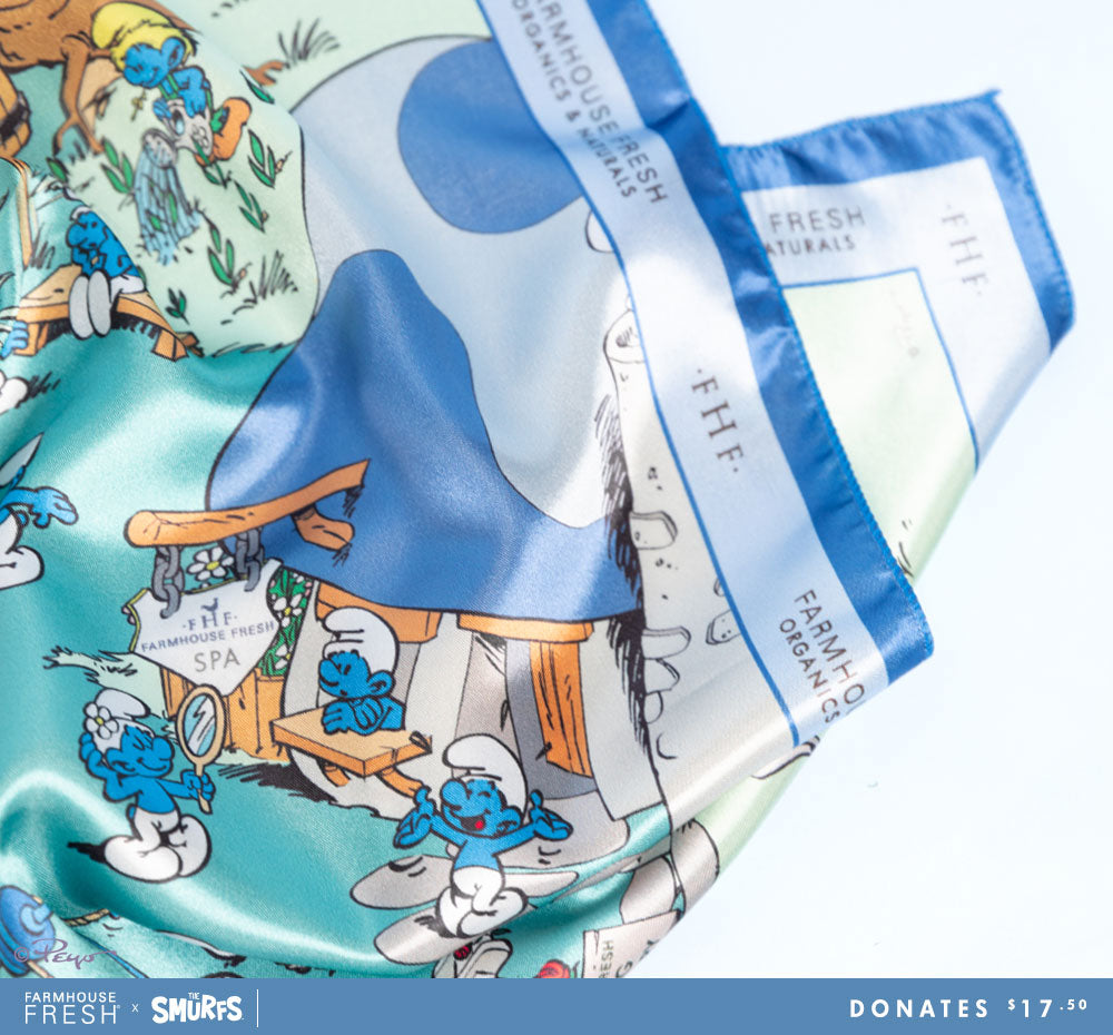 A close-up of FarmHouse Fresh Smurf Village Silky Scarf. All profits donate to animal rescues.