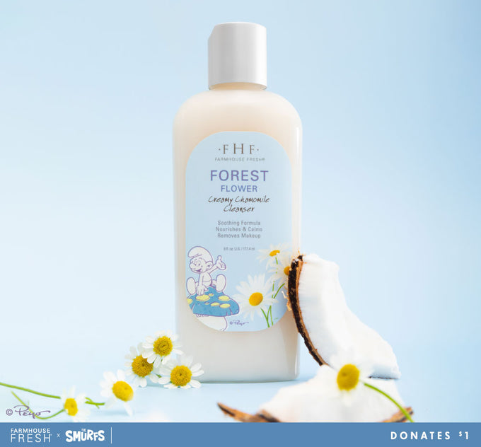 A bottle of FarmHouse Fresh Smurfs collab Forest Flower Creamy Chamomile Cleanser, a creamy face wash for all skin types. Each purchase helps save animals.