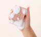 A hand holding a bar of softly scented FarmHouse Fresh Front Porch Punch Shea Butter Bar Soap with rich lather on it.