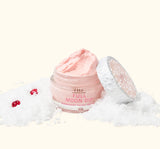 FarmHouse Fresh Full Moon Dip Illumination Mousse body moisturizer styled in snow with festive holiday greenery and red berries