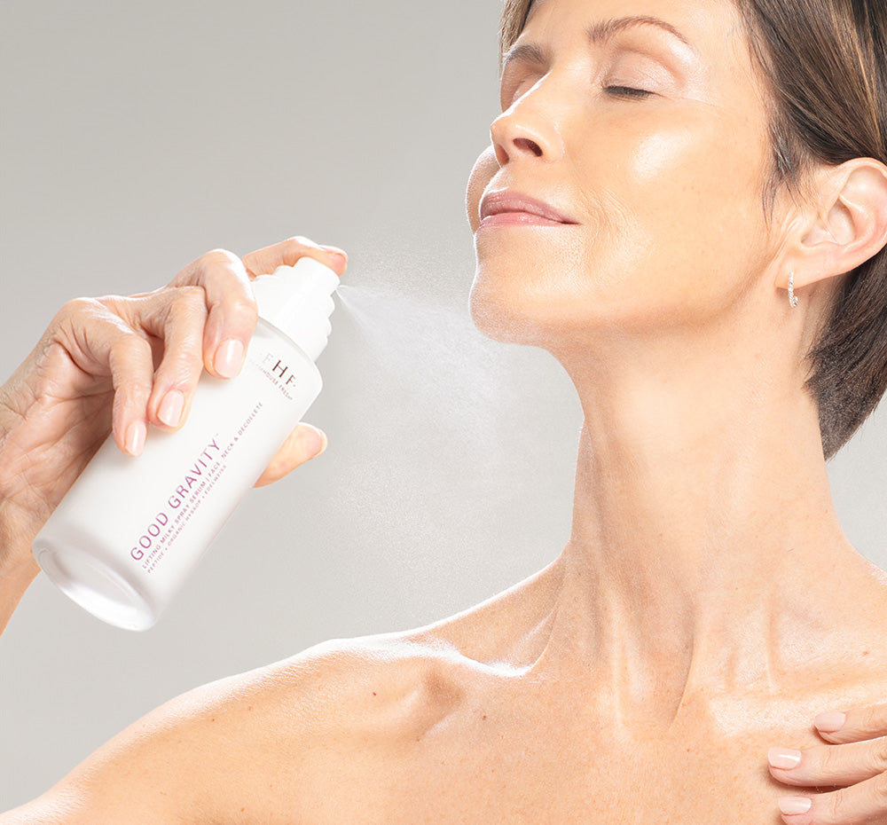 Woman misting her face with FarmHouse Fresh Good Gravity Lifting Milky Spray Serum