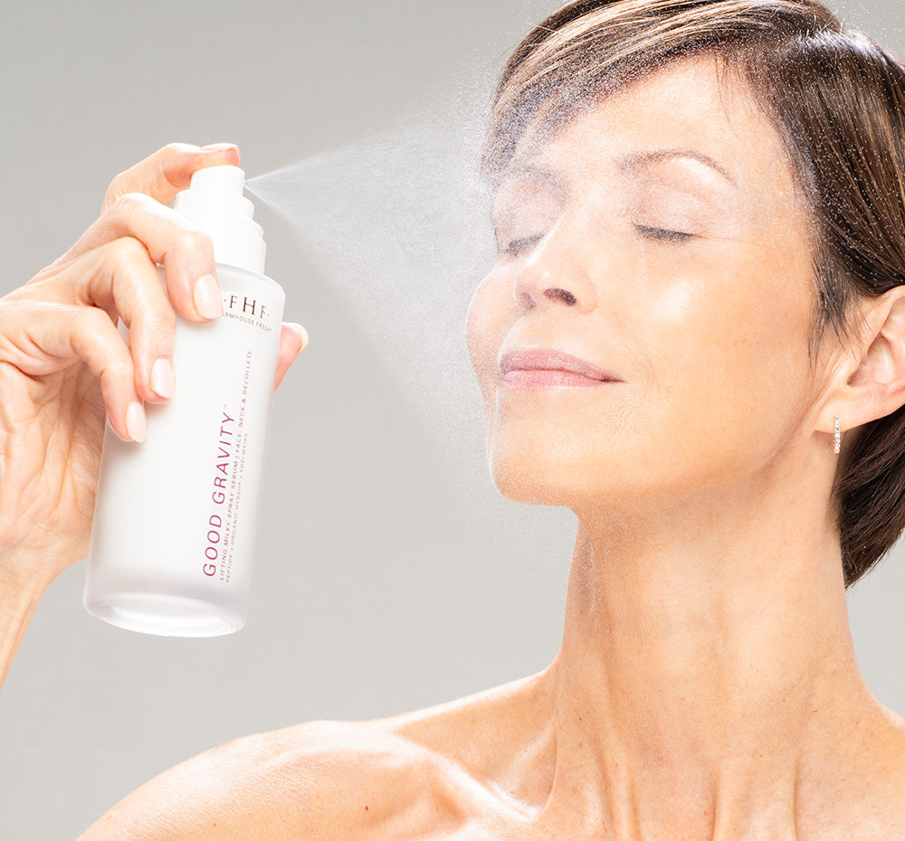 Woman spraying FarmHouse Fresh Good Gravity Lifting Milky Spray Serum onto her face