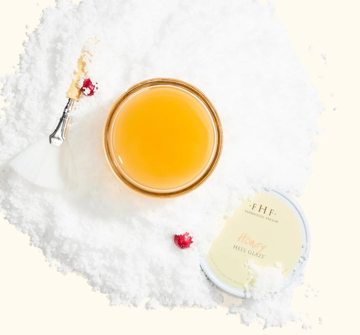 FarmHouse Fresh Honey Heel Glaze honey-based foot treatment styled with festive holiday greenery and red berries