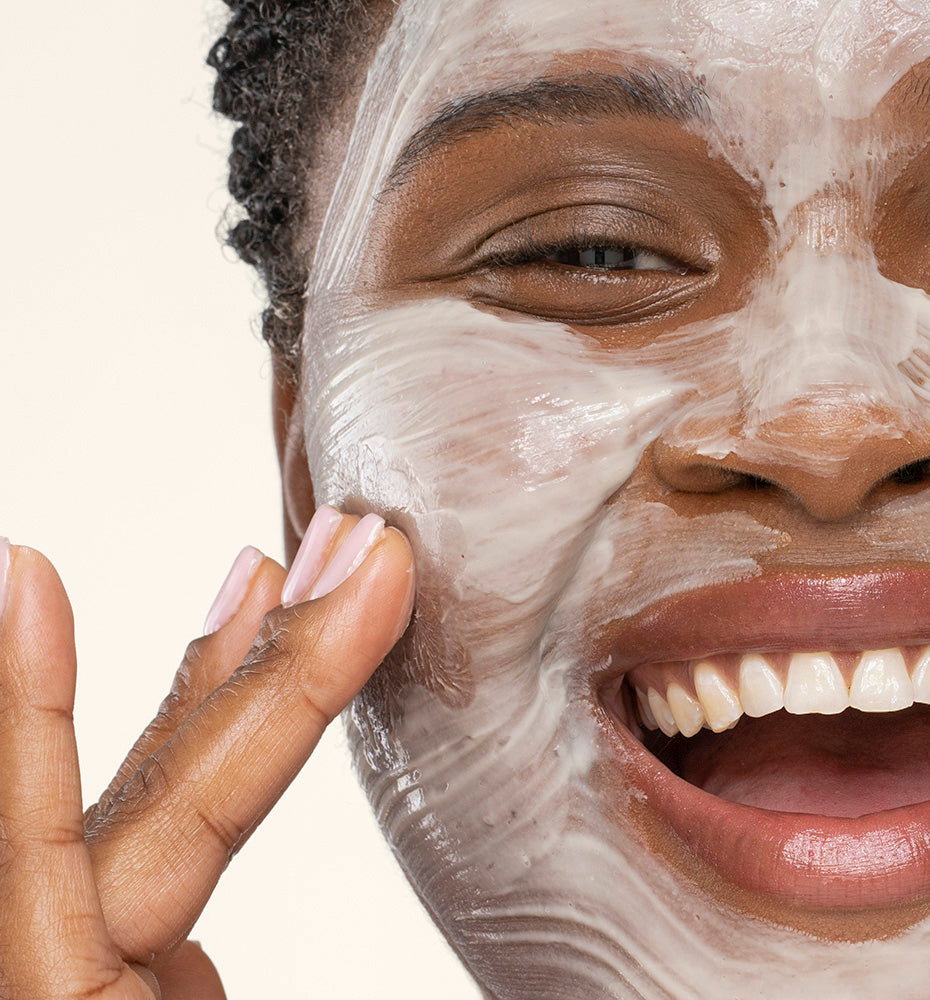 A woman applying Pajama Paste Soothing Yogurt Mask by FarmHouse Fresh on her face to tighten, soften and hydrate her skin.