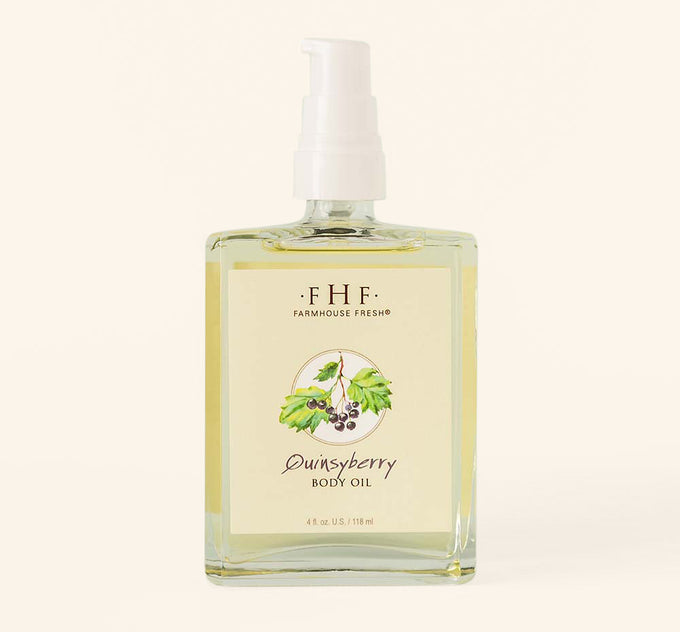 A bottle of FarmHouse Fresh Quinsyberry Botanical Body Oil with a light, unisex apple blossom and tea scent.