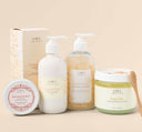 A set of Rainbow Bubbletini body care products by Farmhouse Fresh, including body polish, body wash, shea butter body lotion and a body balm.