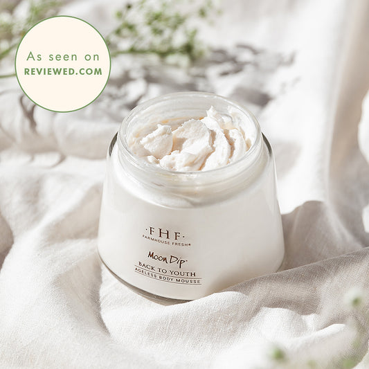 FarmHouse Fresh Moon Dip Back to Youth Ageless Body Mousse in an open jar on white fabric, with “As seen on Reviewed.com” badge.
