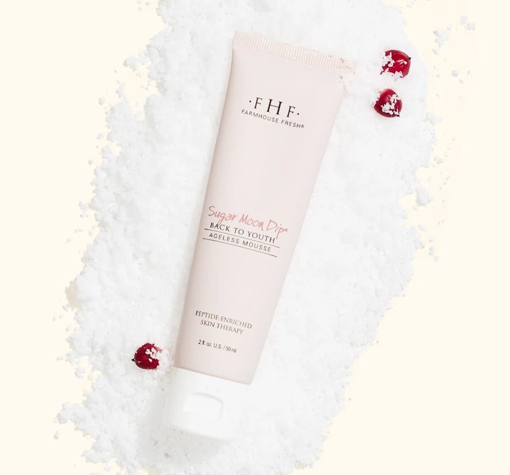 FarmHouse Fresh Sugar Moon Dip Back to Youth Ageless Hand Cream styled with festive holiday greenery and red berries