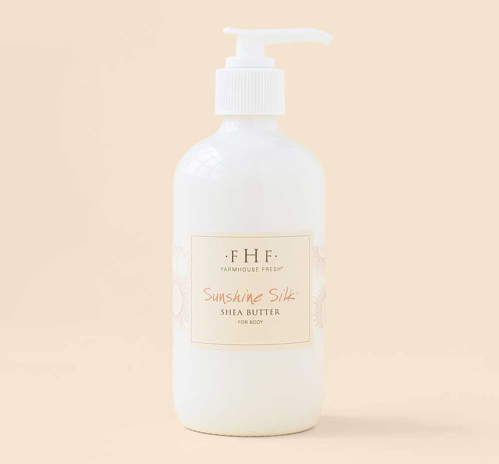 A bottle of FarmHouse Fresh Sunshine Silk Shea Butter that combats dry and sensitive skin.