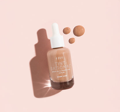 Tint-sational™ Sheer Skin-Perfecting Serum bottle in shade Warm Sand with droplets