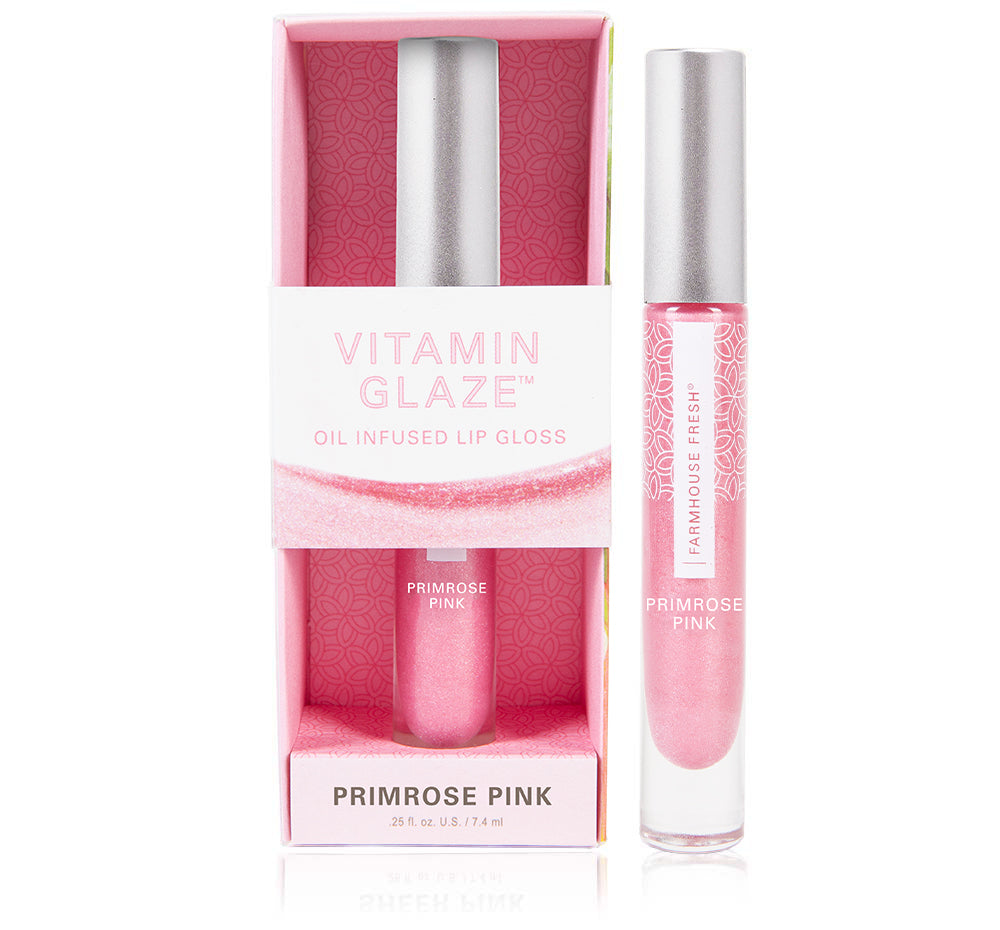 A box and a tube of FarmHouse Fresh Vitamin Glaze Lip Gloss in Sheer Pink color that hydrates lips with no sticky feel.