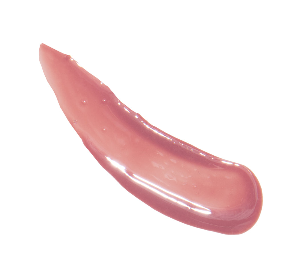 A swatch of FarmHouse Fresh Vitamin Glaze Lip Gloss in Delicate Rose color that moisturizes lips and brings a pretty shine.