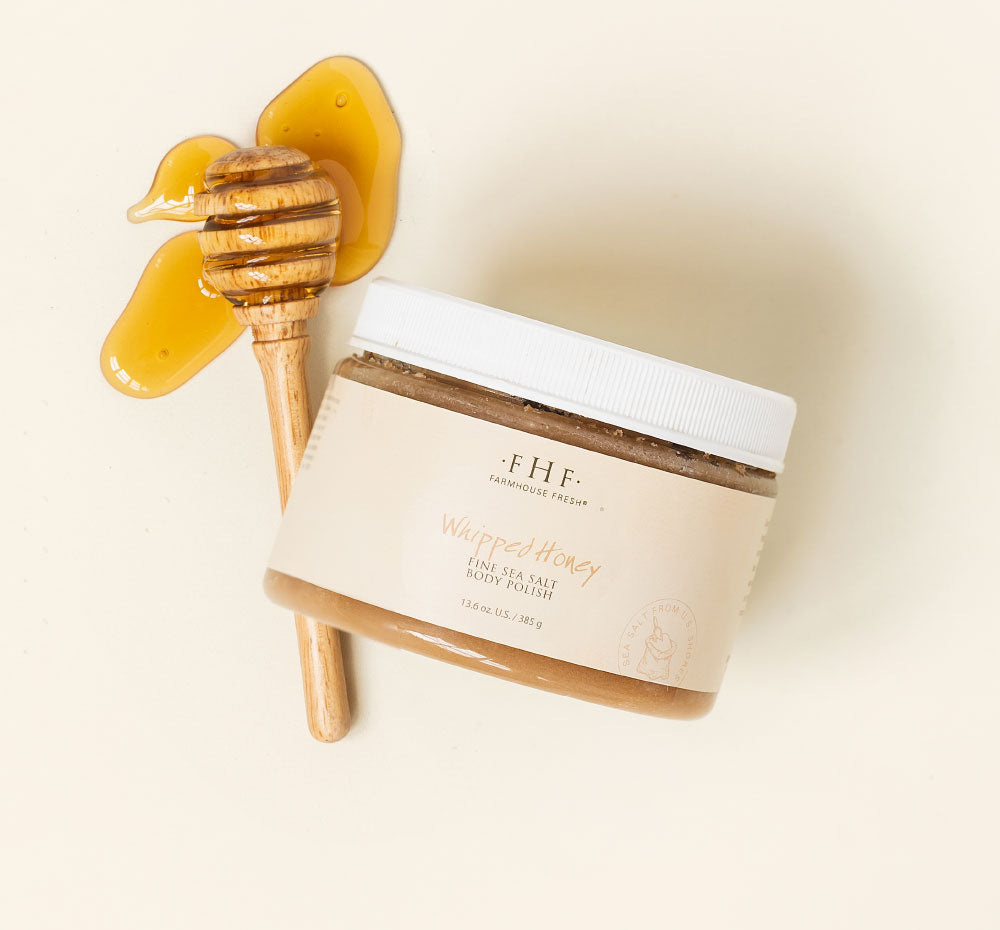 A jar of FarmHouse Fresh Whipped Honey Fine Sea Salt Body Polish scented with notes of honey, clove and nutmeg.