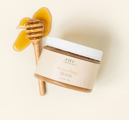 A jar of FarmHouse Fresh Whipped Honey Fine Sea Salt Body Polish scented with notes of honey, clove and nutmeg.
