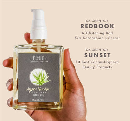 Hand holding a bottle of FarmHouse Fresh Agave Nectar Ageless Body Oil with media mentions about the product on a beige background.