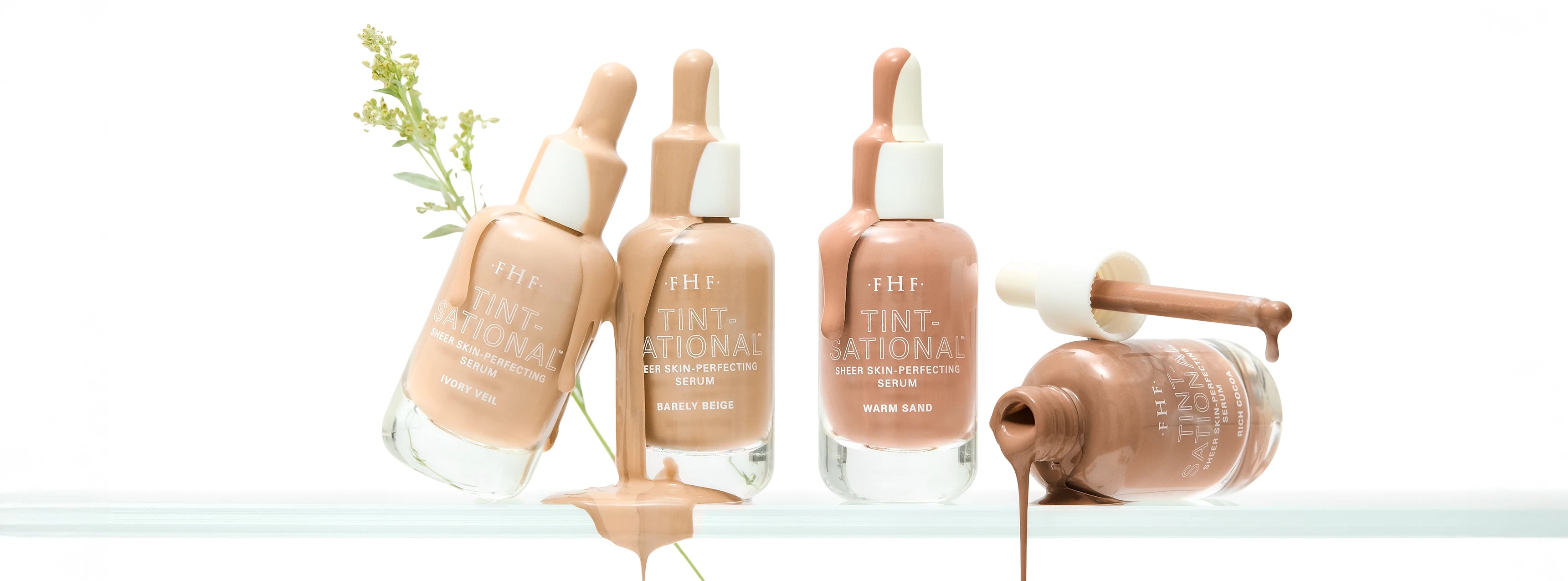 Set of 4 Tint-sational bottles with droppers on a white background with product dripping