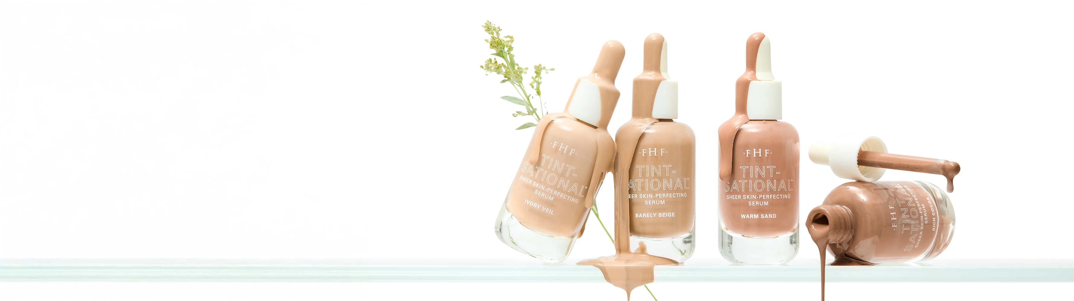 Set of 4 Tint-sational bottles with droppers on a white background with product dripping