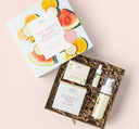 FarmHouse Fresh The Great Awake Brightening Facial Collection gift set that includes a full-size brightening face mask and illuminating facial mousse, plus samples of facial cleanser and vitamin C booster, all nested in a gift box.