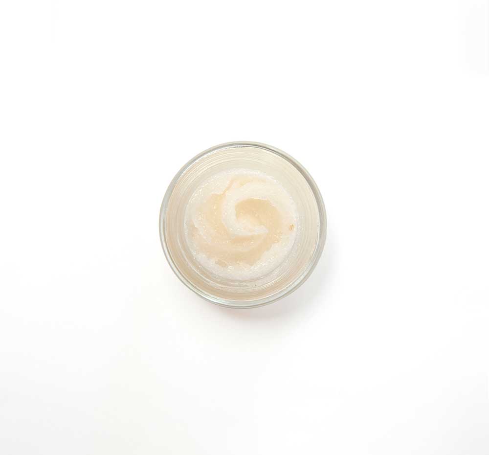 Top view of an open jar filled with Beach Punch Lip Polish by FarmHouse Fresh, made with date sugar and pineapple juice.