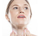 A woman is applying FarmHouse Fresh Blissed Moon Dip Back To Youth Ageless Mousse on her neck to smooth the look of wrinkles.