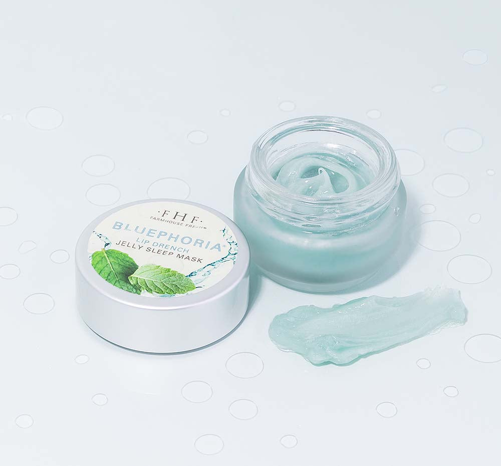 An opened jar of FarmHouse Fresh Bluephoria Lip Drench Jelly Sleep Mask that deeply hydrates lips.