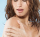 A woman exfoliating her shoulder with Farmhouse Fresh's Brandy Pear body scrub with nourishing oils.