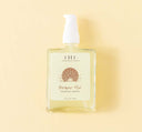 A bottle of Farmhouse Fresh Bronze Fox Tanning Drops on a vibrant yellow background.