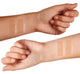 Two arms of different skin color displaying swatches of Farmhouse Fresh Bronze Fox tanning drops.