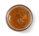 A jar of Farmhouse Fresh Butter Rum Scrub, a brown sugar body scrub for dry skin, placed on a white background.