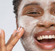 A woman applying Pajama Paste Soothing Yogurt Mask by FarmHouse Fresh on her face to tighten, soften and hydrate her skin.