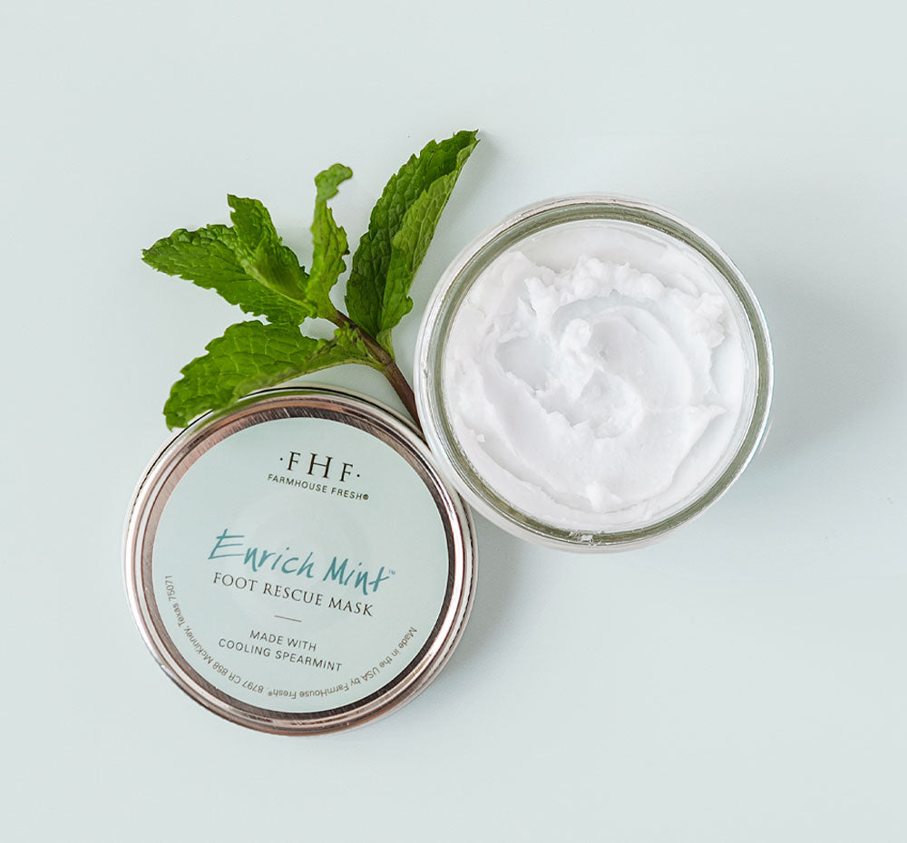 An opened jar of FarmHouse Fresh Enrich Mint Foot Rescue Mask that instantly moisturizes and brings comfort to cracked heels.