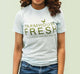 A woman wearing a FarmHouse Fresh® Donation T-Shirt in Blue color.