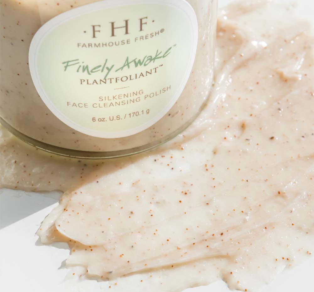 A jar and a smear of Finely Awake Face Polish from Fast Fresh Facial Set by FarmHouse Fresh that shows the exfoliatig texture of the product.