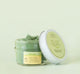 A jar of Farmhouse Fresh Guac Star hydrating face mask with a lid next to it.