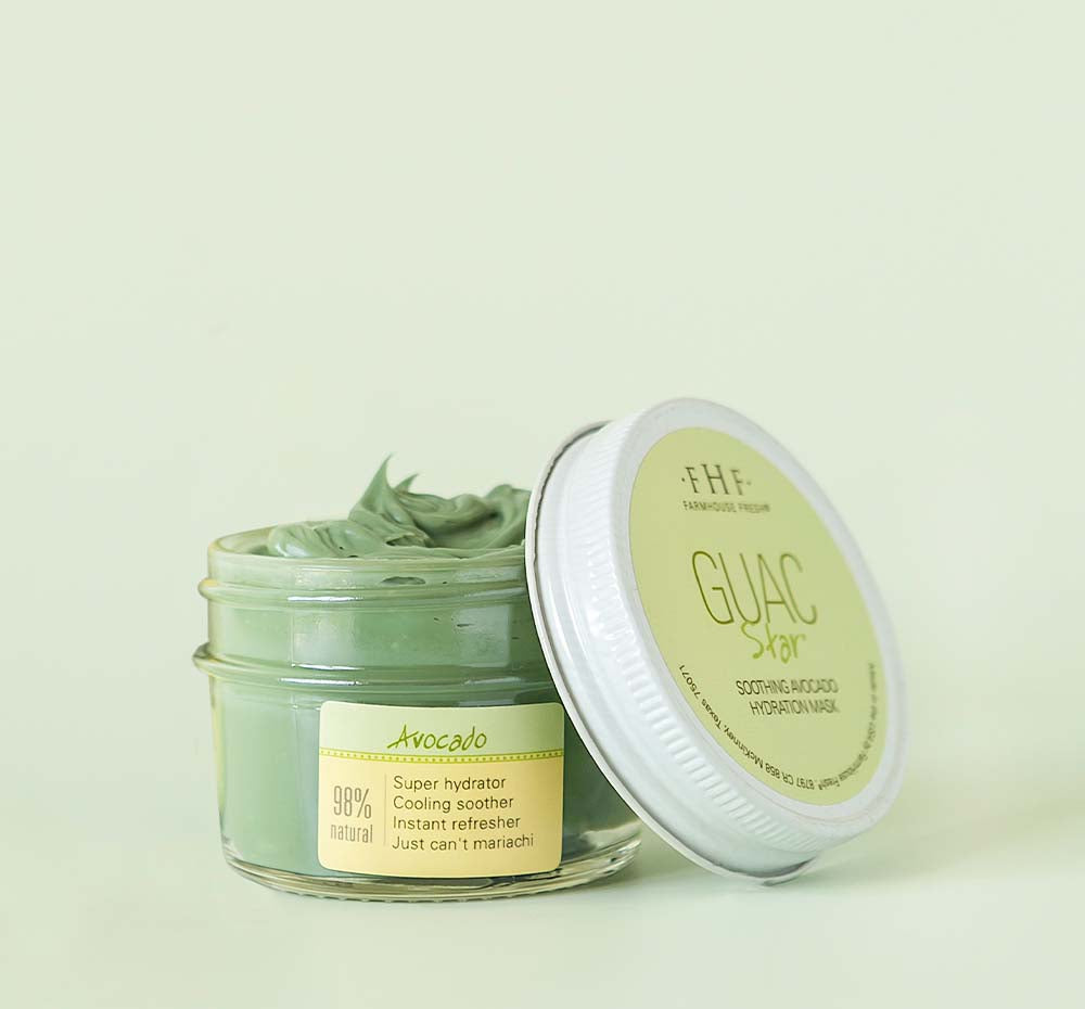 A jar of Farmhouse Fresh Guac Star hydrating face mask with a lid next to it.